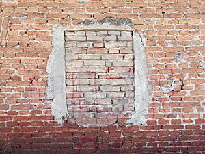 Closed window in an old wall. Old age and blindness. Walled window