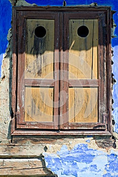 Closed window with old wood shutters