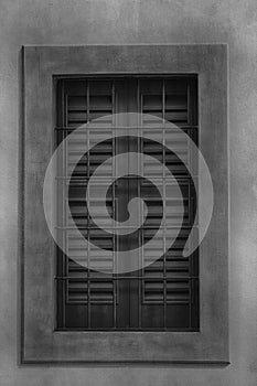 Closed window with old wood shutters, monochrome background