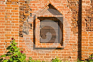 Closed window on a wall of old manor