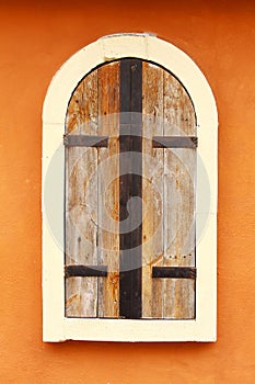Closed Wood Window on Orange Wall