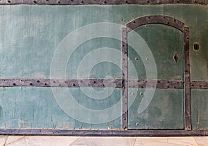 Closed wooden blue door in a wooden blue wall