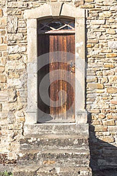 Closed wooden door of a stone residential building