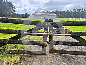 Closed wooden gate of agriculture farm