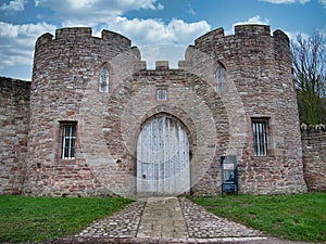 Closed wooden gates at an entrance to the medieval Beeston Castle, standing above the Cheshire Plain in the UK