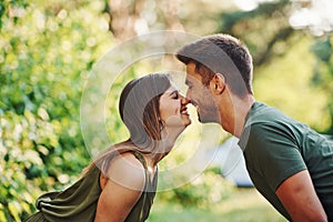 Closeness of people. Beautiful young couple have a good time in the forest at daytime