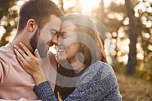 Closeness of the people. Cheerful lovely young couple having a rest outdoors together