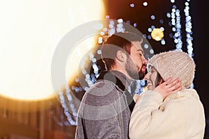 Closeness of the people. Happy young couple celebrating New year outdoors on the street