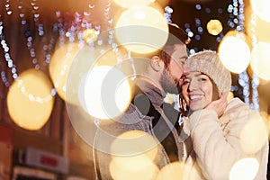 Closeness of the people. Happy young couple celebrating New year outdoors on the street