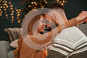 Closeness of the people. Lovely young couple are celebrating New Year at home