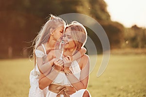 Closeness of people. Mother and daughter enjoying weekend together by walking outdoors in the field. Beautiful nature