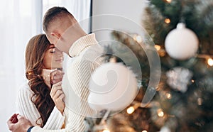 Closeness of the people. Young romantic couple celebrates New year together indoors