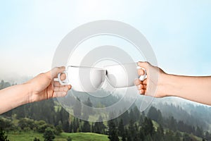 Closeness to nature. Couple with cups in mountains, closeup