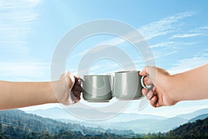 Closeness to nature. Couple with cups in mountains, closeup