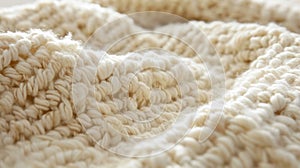 A closer look at this fluffy woolen reveals a tightly knit grid pattern of creamcolored fibers creating a cozy and photo
