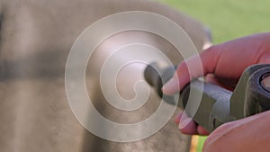 The closer look of the pressure washer with the water.4K. Person hands.