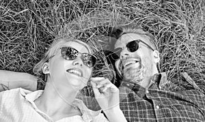 Closer to nature. Nature fills them with freshness and inspiration. Man unshaven and girl lay on grass meadow. Guy and