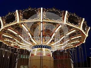 Closest picture of a wave swinger with bright lights at sunset at the Jakarta theme park