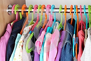 Closet with baby dresses on hangers