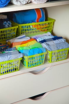 Closet with children`s things. Storage of children`s clothes.