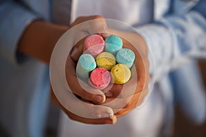 Closeuop childs hands holding colored chalks for drawing.