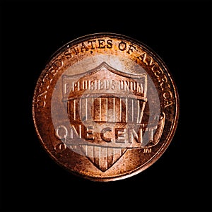 Closeup of a 1 US dollar cent coin also called penny from 2016 isolated on a black background