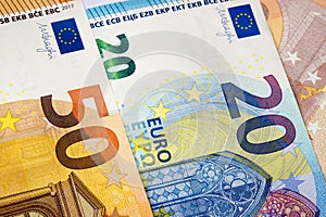 Closeup of 20 and 50 euro banknotes as money background.