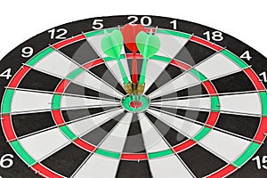 Closeup 3 red and green dart arrow is on target center of dartboard isolated and white background