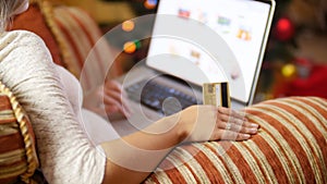 Closeup 4k footage of young woman sitting in armchair and making online orders in store. Concept shot of online shopping