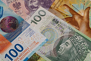 Closeup of 50, 100 and 200 Swiss franc banknotes and 100 polish zloty banknotes