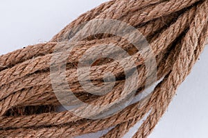 Closeup of 8mm jute rope laid diagonal across white background