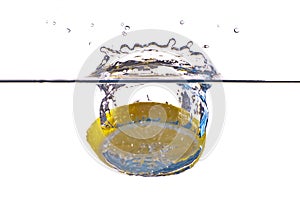 Closeup abstract yellow lemon splashing in water