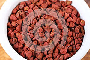 closeup achiote seeds over white background