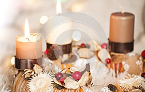 Closeup of Advent wreath with two burning candle and Christmas lights in background