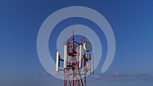 Closeup aerial view on the telecommunication tower with 5g 4g cellular dishes