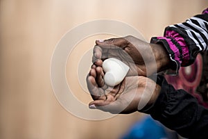 Closeup of African-American girl holding a marble made heart shape in her hands