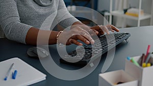 Closeup of african american student hands working at communication project