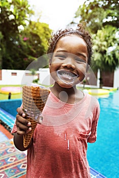 Closeup of african descent girl with ice cream by the pool