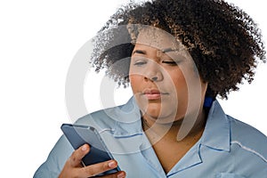 closeup, Afro-Latina medical woman of Venezuelan ethnicity reading using her phone, white background