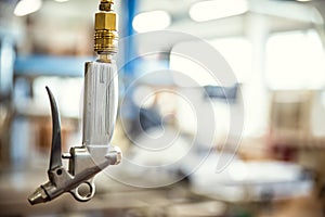 Closeup of an air gun in a carpentry or workshop