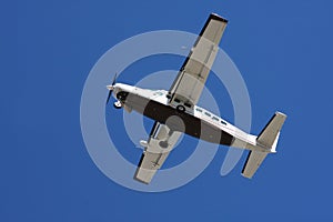 Closeup of airplane belly in blue sky