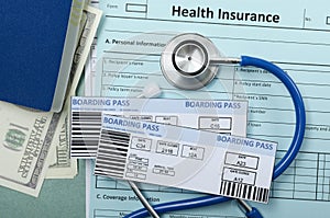 Closeup of airplane tickets, stethoscope, cash, passport, health insurance police.Concept of travel safety