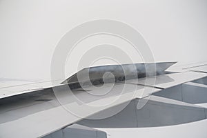 Closeup of airplane wing during landing in heavy clouds
