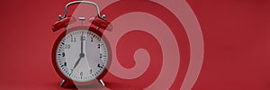 Closeup of alarm clock on red background