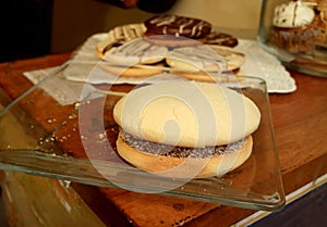 Closeup of Alfajores, a traditional Latin American sweets filled with Dulce de Leche served on glass plate