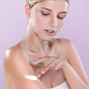 Closeup alluring beautiful woman apply moisturizer cream on her arm concept.