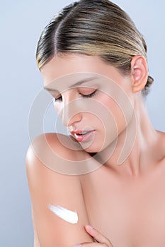 Closeup alluring beautiful woman applying moisturizer cream on her arm concept.