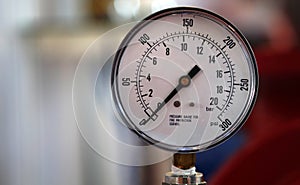 Closeup of analog meter in a manufacturing unit