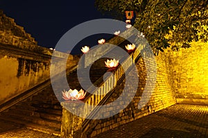 Closeup ancient architectural building with Buddhism garland flowers a night