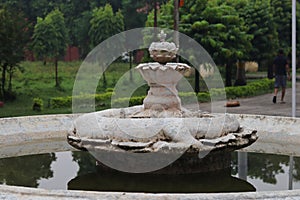 Closeup of an ancient inactive fountain in the garden of Taj palace